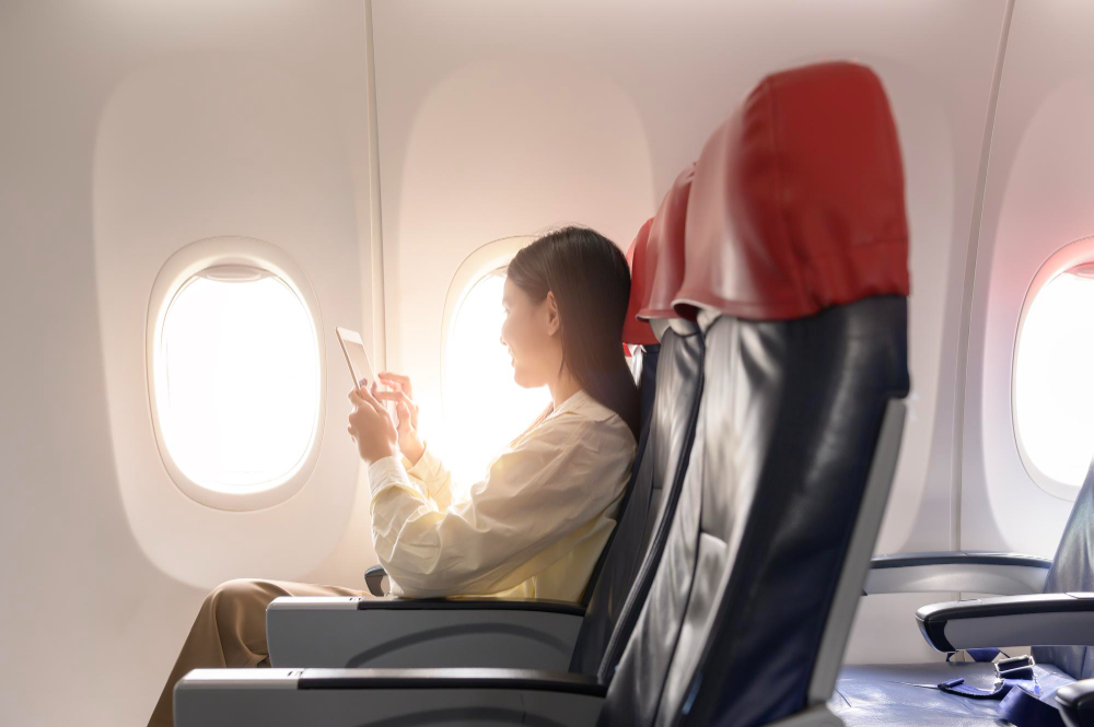 beautiful-asian-woman-is-working-with-smartphone-tablet-airplane