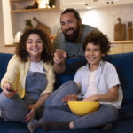 close-up-child-watching-movies-with-parents