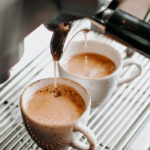 two espresso cups under coffee engine _
